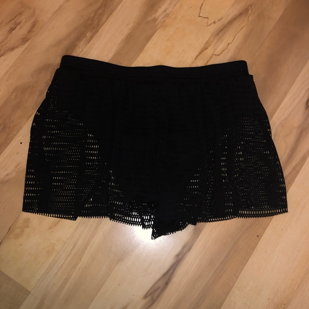 Black swimsuit bottom with mesh shorts coverup